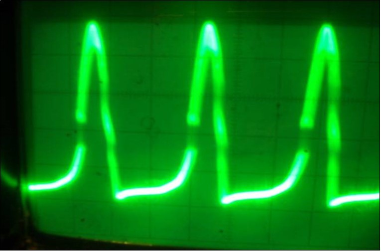Oscillograph of the collector voltage in the physical model of the system (7) corresponding to the solution of the KdV equation. Vert axis milli sec/cm, Horiz axis-3volts per cm.